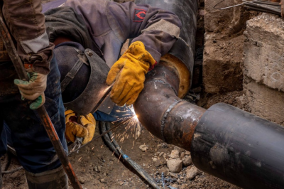 An image of workers welding public water pipes. 